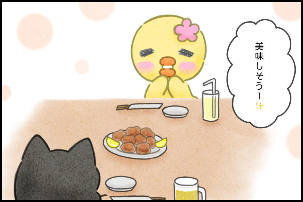 居酒屋で唐揚げを頼むぴのりとクロにゃん